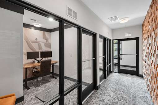 Modern conference room with glass partition doors at Link ® Lake Park Apartments, Smyrna, GA 30080