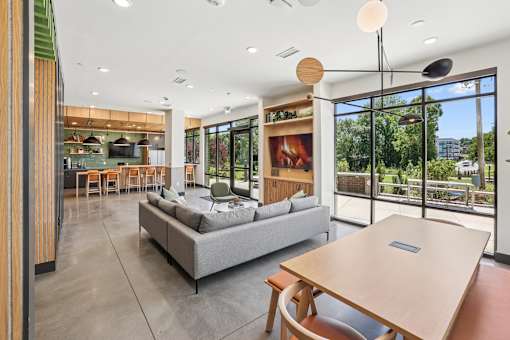 A modern living room with a grey sofa and a wooden table at Link Apartments® CYKEL Apartments, Charlotte