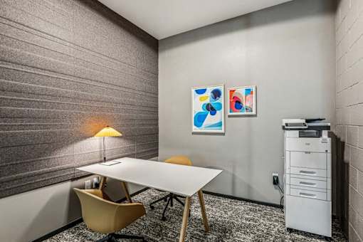 a conference room with a table and chairs and a filing cabinet at Link Apartments® Four 12, Oakland, 94607