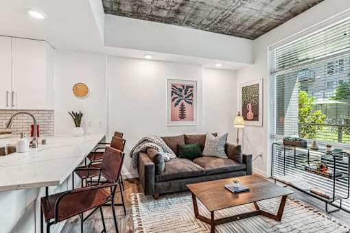 the living room of an apartment with a couch and a table at Link Apartments® Four 12, Oakland, CA, 94607