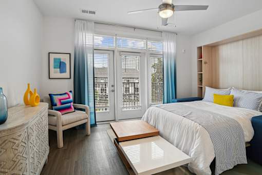 a bedroom with a bed and a sliding glass door at Link Apartments® Mint Street, Charlotte, North Carolina