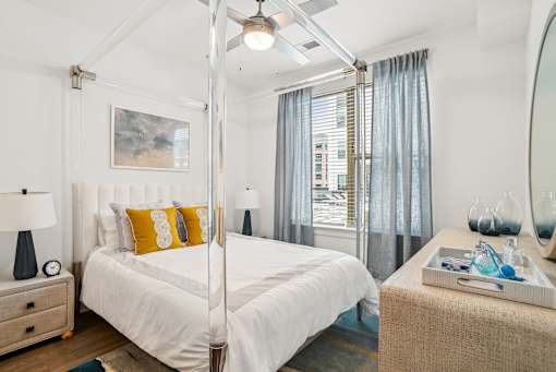 a bedroom with a white bed and a large window at Link Apartments® Mint Street, North Carolina, 28203