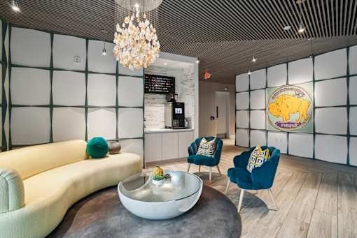 a living room with a couch and chairs and a coffee table at Link Apartments® Mint Street, Charlotte, NC, 28203