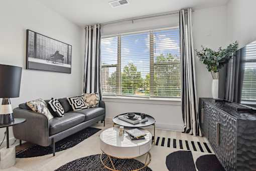a living room with a couch and a coffee table at Link Apartments® Mint Street, Charlotte, NC, 28203