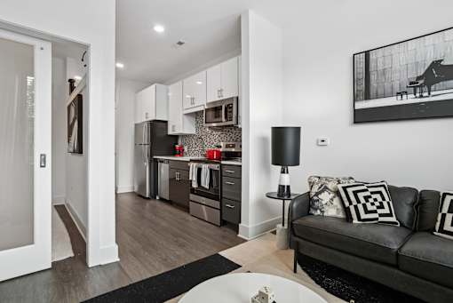 a living room with a couch and a table at Link Apartments® Mint Street, North Carolina
