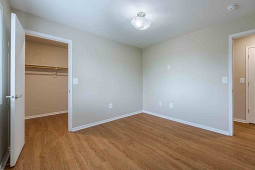 A room with a wooden floor and white walls.