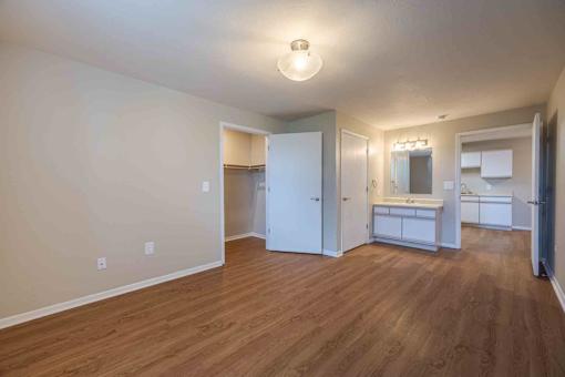 A room with wooden floors and white walls.