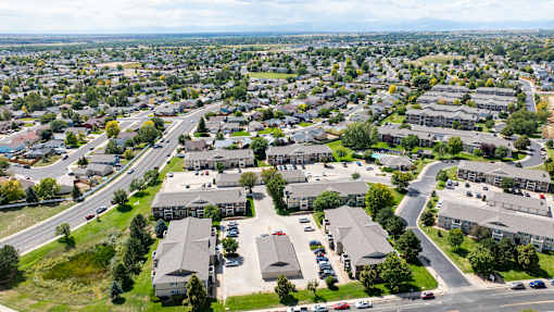 A bird's eye view of a residential area with houses and roads.