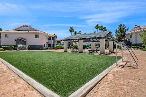 A house with a green lawn and a playground.