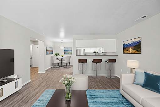 A modern living room with a bar area and a television.