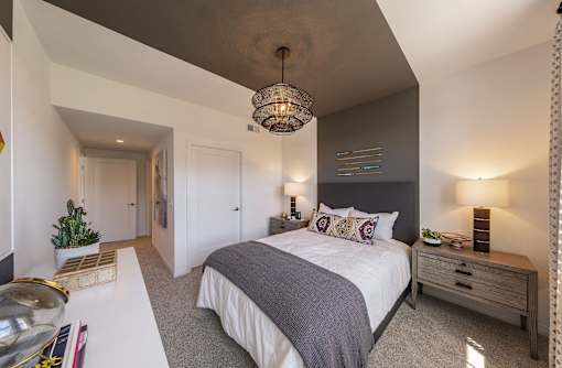 a bedroom with a large bed and a white table