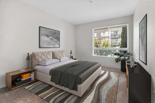 a bedroom with a bed and a large window