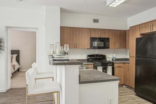 a kitchen with an island and a stove and a refrigerator