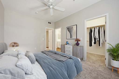 a bedroom with a bed and a ceiling fan