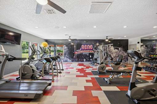 A gym with treadmills and exercise equipment.