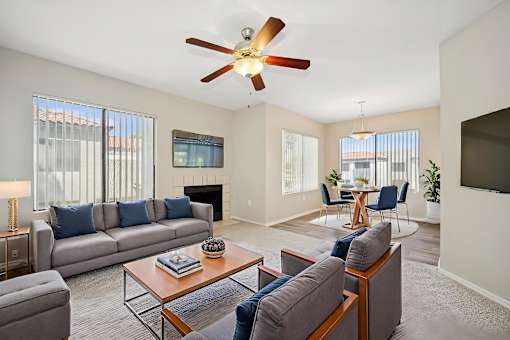 A living room with a grey couch and a coffee table.