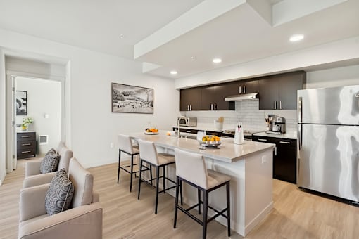 A modern kitchen with a dining table and chairs.