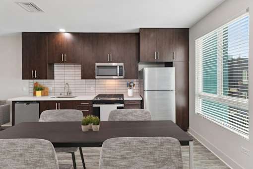 A modern kitchen with a table and chairs.