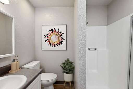 a bathroom with a toilet and a sink and a shower