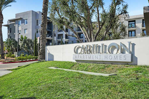 The image shows a sign for Carillon Apartment Homes