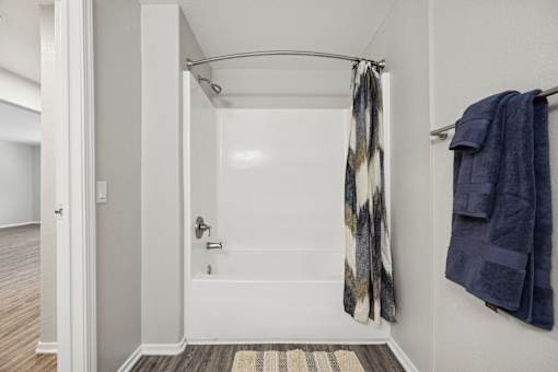 A bathroom with a towel hanging on the wall.