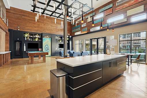 A modern kitchen with a long island in the middle.