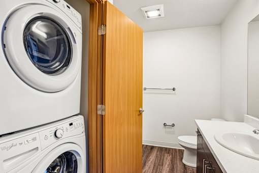 A white washing machine and dryer in a small laundry room.