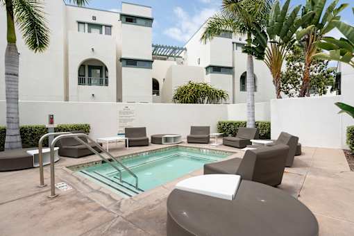 A pool area with a white building in the background.