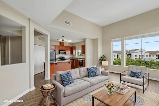 A living room with a grey couch and a coffee table.