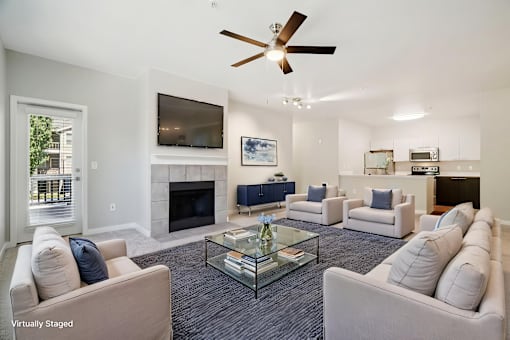 A living room with a fireplace and a television.