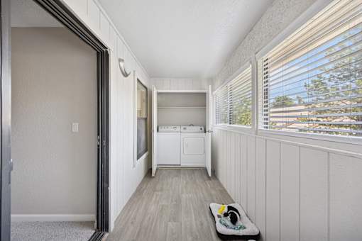 A small laundry room with a washer and dryer.