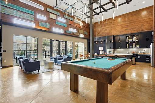 A billiard table is in the middle of a room with a pool table and a bar.