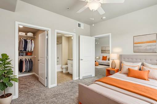 A bedroom with a bed, a wardrobe, and a potted plant.
