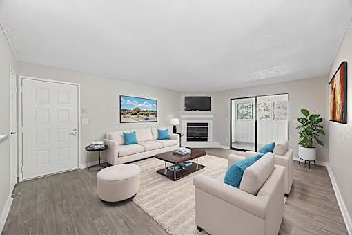 A living room with a white couch and a coffee table.