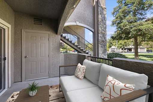 a patio with a couch and a table and a door