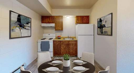 a kitchen and dining room with a table and chairs