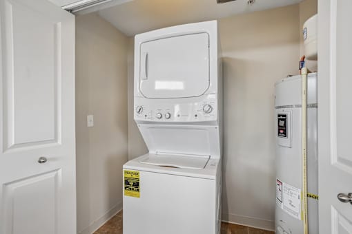 A white dishwasher and refrigerator in a small kitchen.