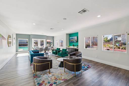 A living room with a blue couch and a rug.