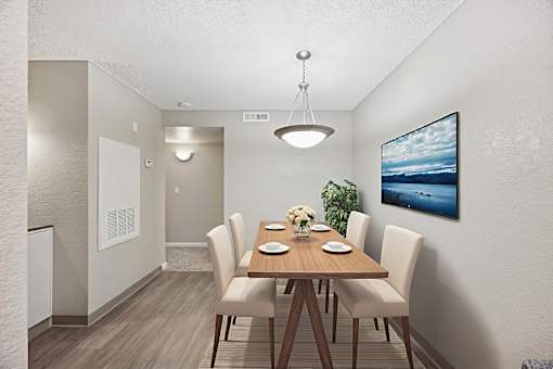 A dining room with a wooden table and chairs.