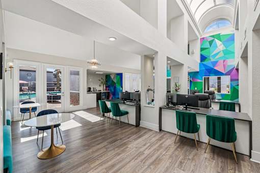 A modern office space with a glass ceiling and a large mural on the wall.