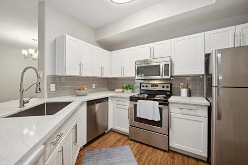 a kitchen with stainless steel appliances and white cabinets