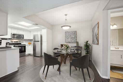 a dining room with a table and black chairs