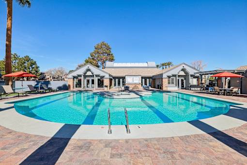 A large swimming pool with a fountain in the middle of it.