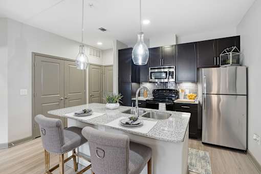 A modern kitchen with a dining table and chairs.