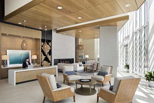 A modern waiting room with a reception desk and comfortable seating.