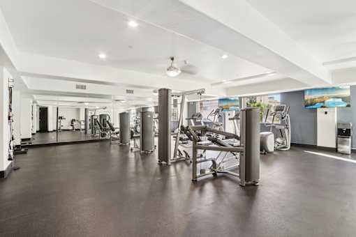 A spacious gym with a variety of equipment.