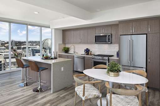 A modern kitchen with a dining table and chairs.