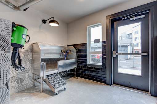 a laundry room with a sink and a door to a street