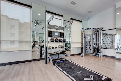 a home gym with exercise equipment and glass doors