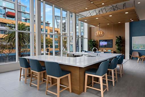A modern dining room with a long table and chairs.